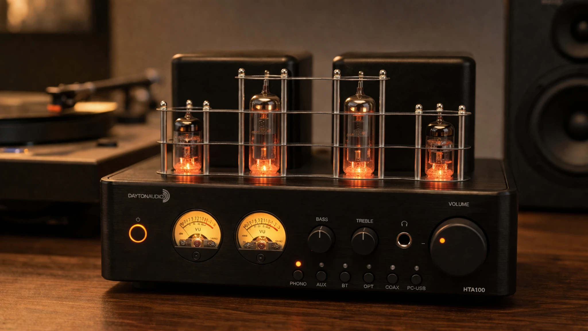 Dayton Audio HTA100 tube amplifier close-up with glowing vacuum tubes and VU meters