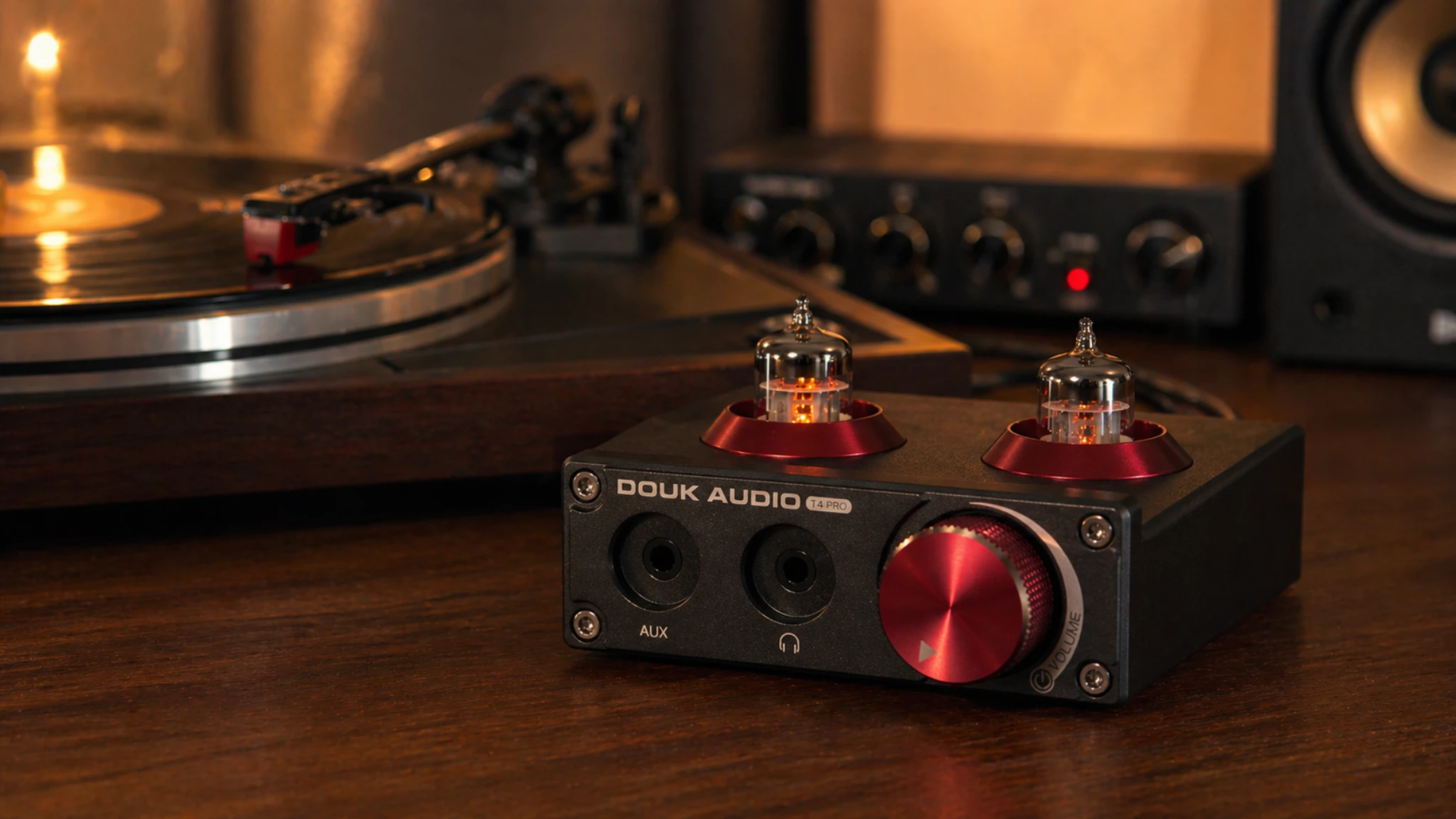 Douk Audio T4 Pro tube phono preamp with glowing tubes in a warm vinyl listening setup