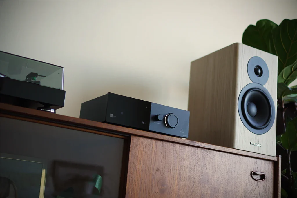 modern bookshelf speakers setup in living room with integrated amplifier