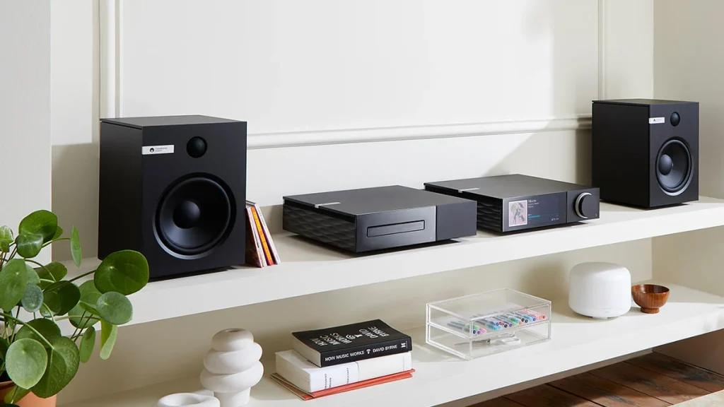 Modern Cambridge Audio amplifier and bookshelf speakers setup on a desk, ideal for stereo listening.