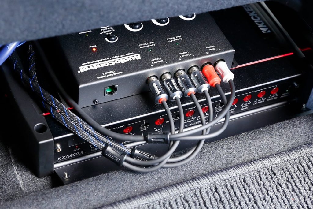Compact 4-channel car amplifier mounted under seat for clean stealth install