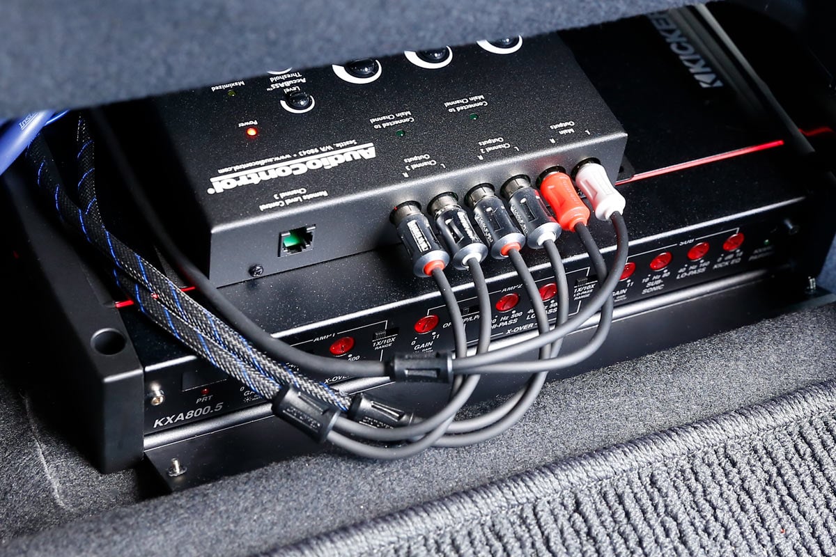 Compact 4-channel car amplifier mounted under seat for clean stealth install