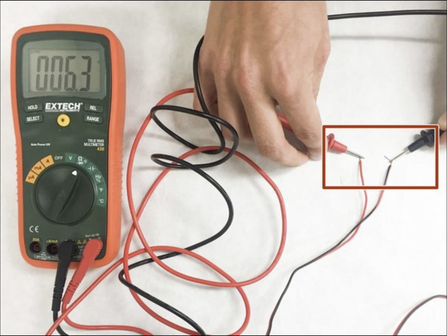 Using a multimeter to check speaker polarity and continuity before powering amp