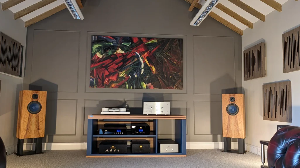 High-end home audio listening room showcasing premium amplifier brands and floorstanding speakers