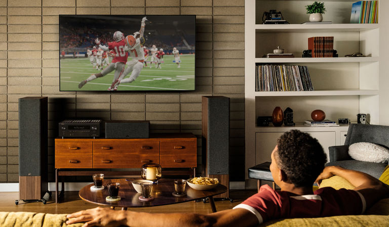 Denon amplifier powering a modern home theater setup for TV and sports viewing