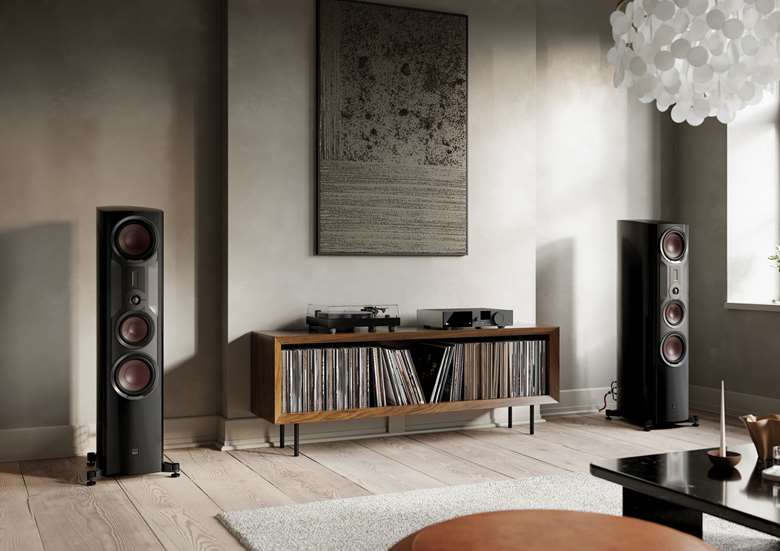 Balanced home audio system with floorstanding speakers and an amplifier in a calm living room, illustrating when an amplifier may quietly limit system performance