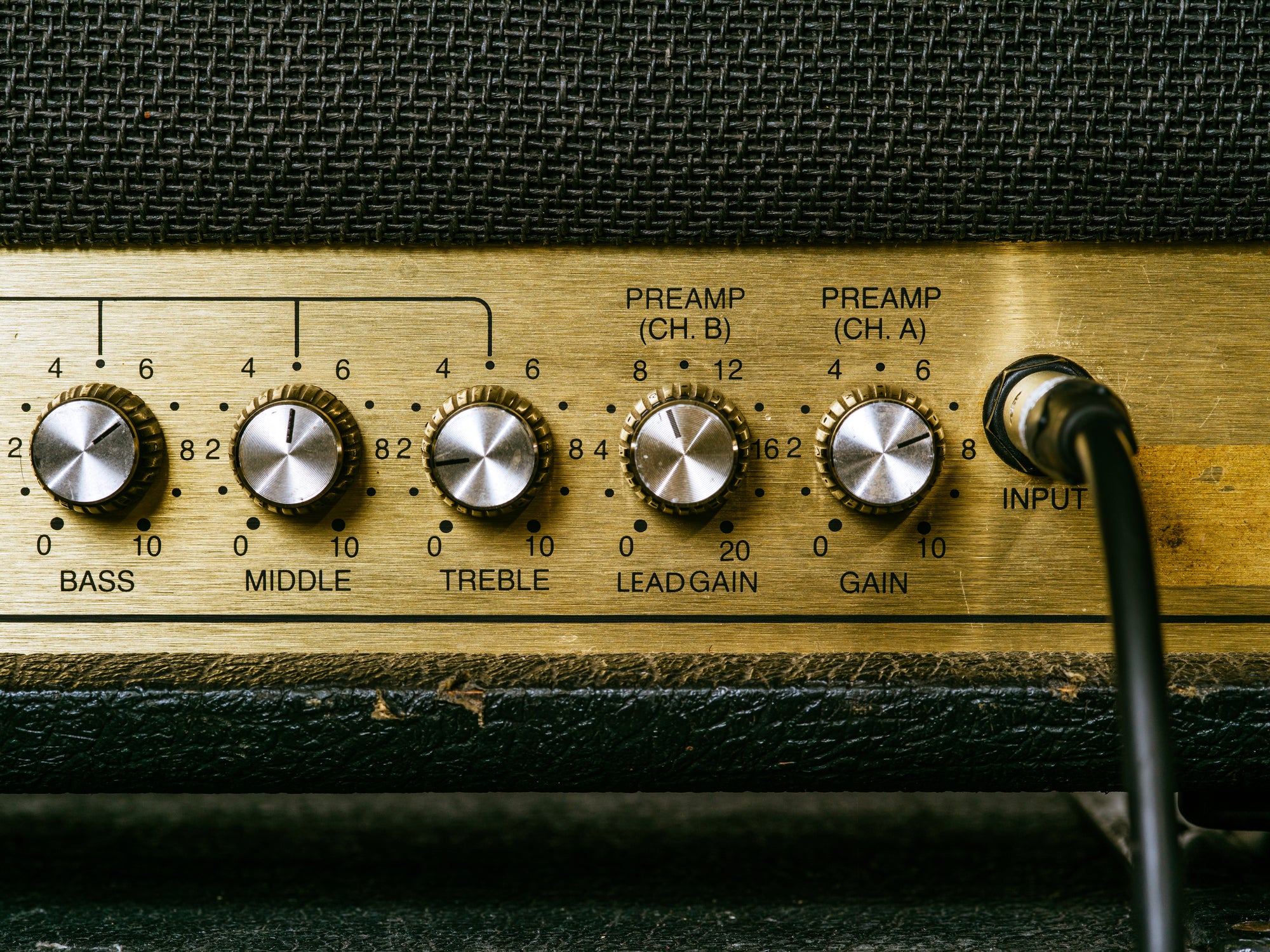 Amplifier control knobs set at moderate levels showing realistic listening volume