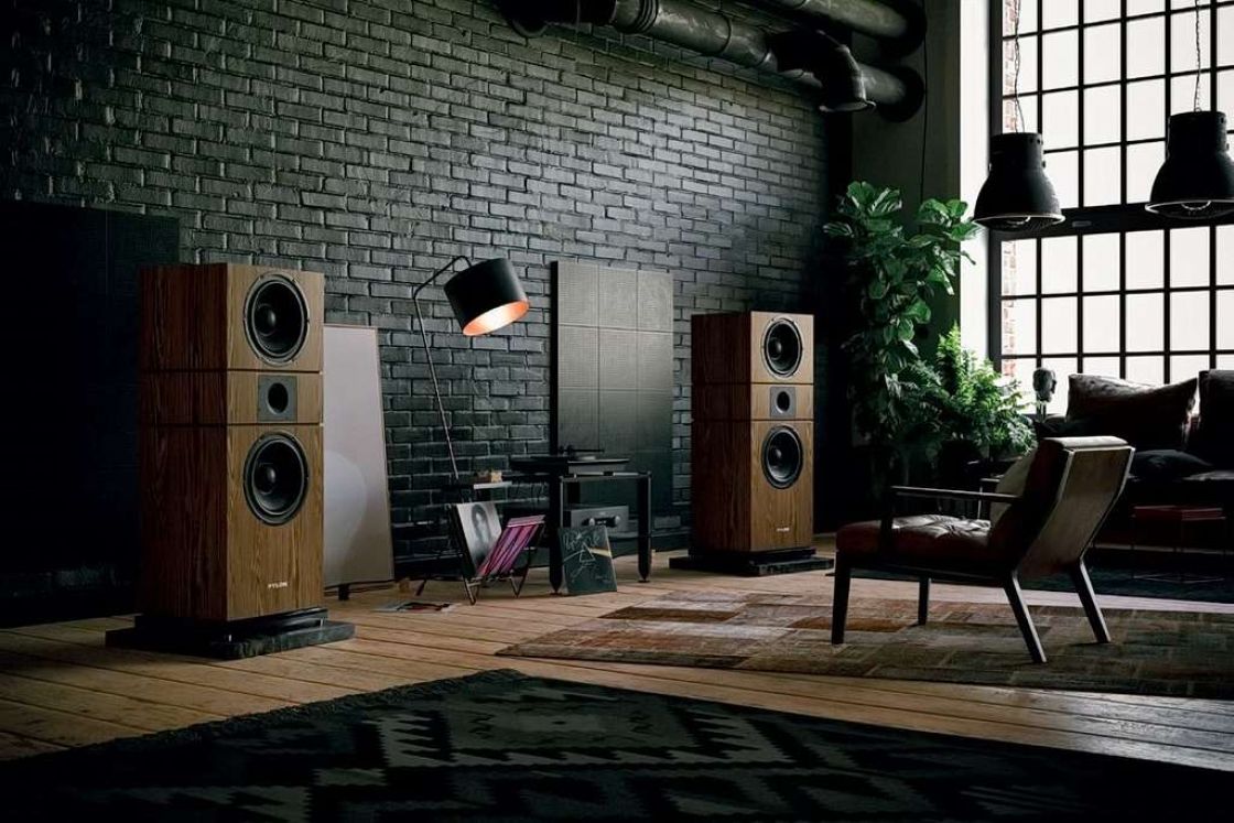 High-end home audio setup with large floorstanding speakers and amplifier in a spacious living room