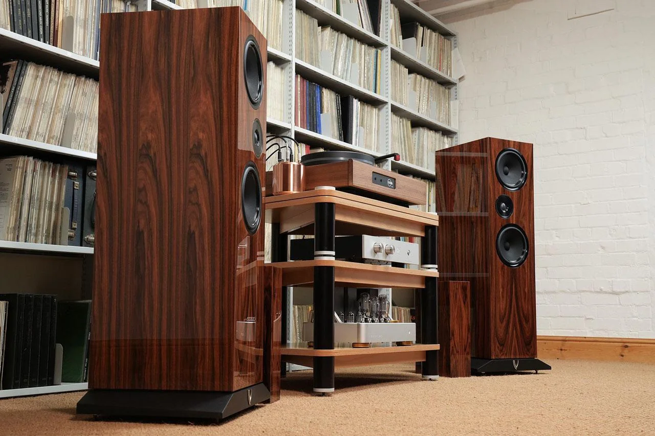 high-end audio setup with floorstanding speakers and amplifier in a premium listening room