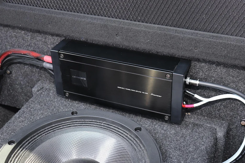 2-channel car amplifier installed in a vehicle trunk