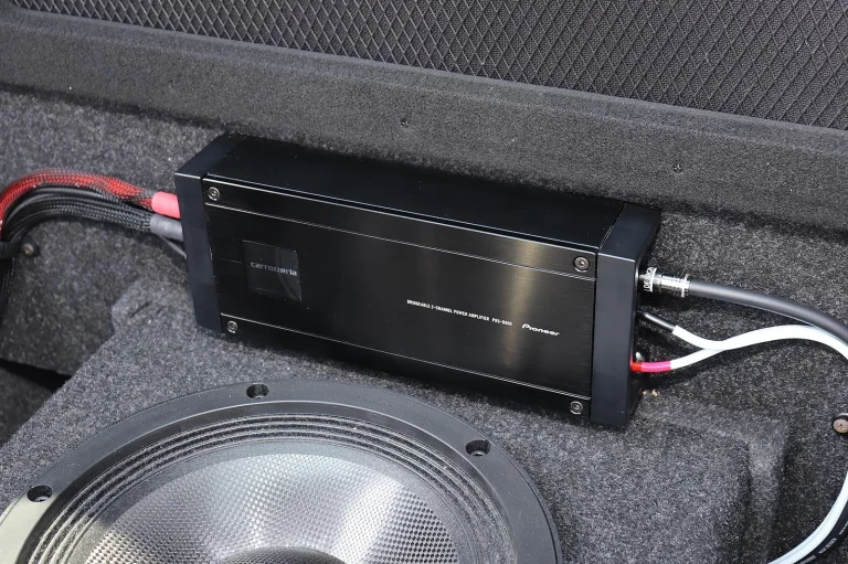 2-channel car amplifier installed in a vehicle trunk