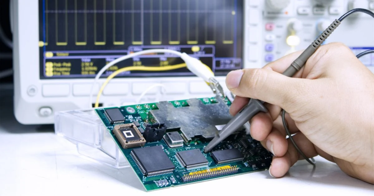 Technician checking car amplifier power circuitry with a multimeter