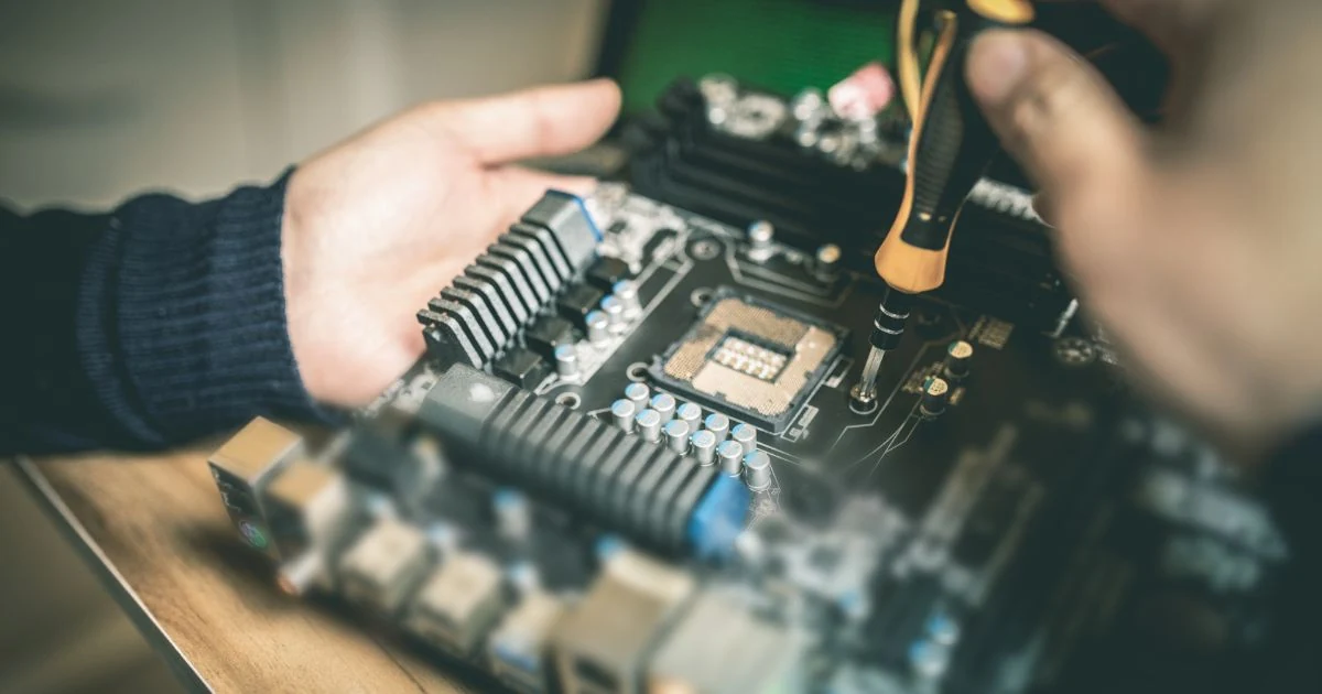 Technician inspecting car amplifier speaker wiring and terminals