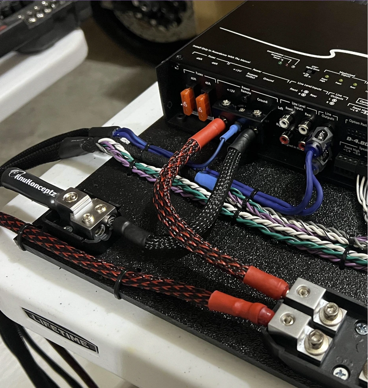 Car amplifier wiring kit components laid out before installation