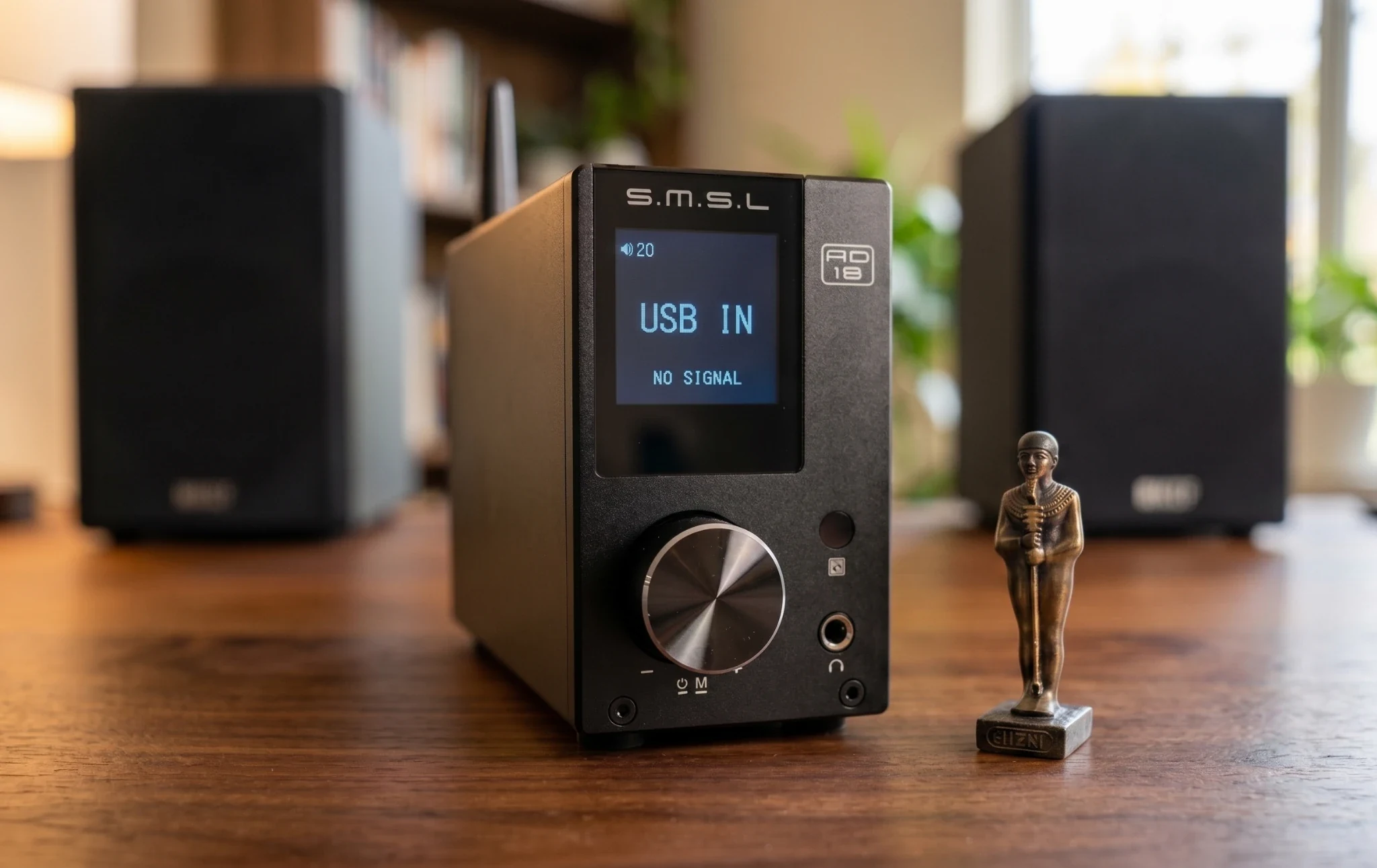 SMSL AD18 desktop DAC amplifier beside a computer and passive bookshelf speakers