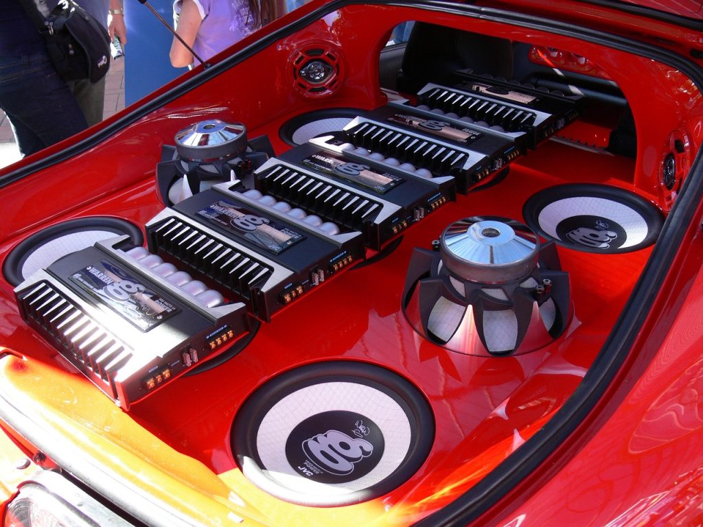 Car audio system installed in vehicle trunk with subwoofer and amplifier